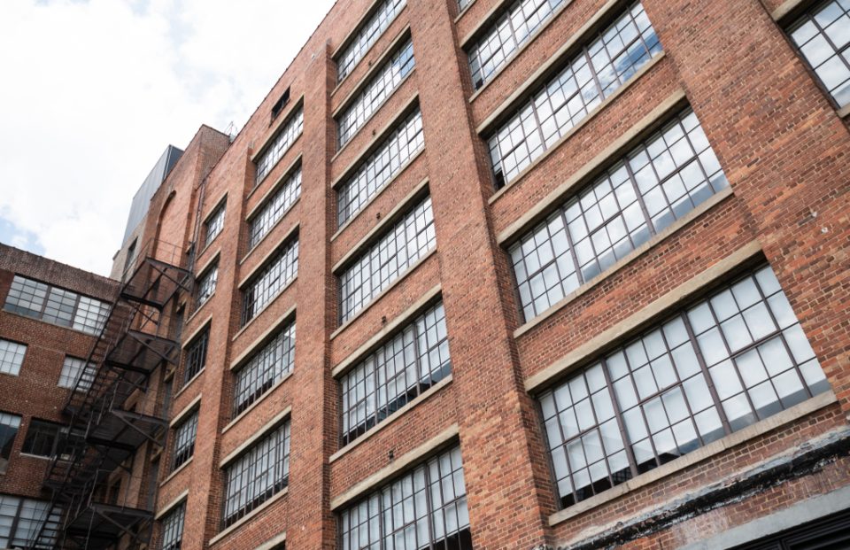 Red brick apartment building against an overcast sky