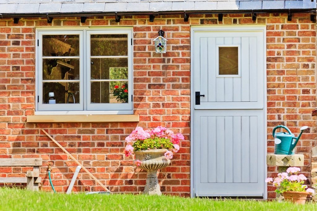Brick cottage with a white front door and cottage window